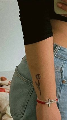 a woman with a flower tattoo on her left arm and the back of her stomach