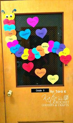 a bulletin board with hearts on it in front of a door that says i love you