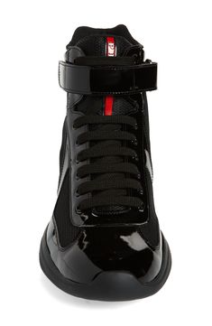 Prada creates a high-top version of its cult sneaker, which was originally designed for the Luna Rossa sailing team to wear during the 2000 America's Cup. It's crafted from a mix of patent leather and breathable mesh with a lightweight, flexible sole sporting the iconic red logo. Style Name:Prada America's Cup Bike High Top Sneaker (Men). Style Number: 6271519. Designer High-top Sneakers With Round Toe For Sports, Designer Round Toe High-top Sneakers For Sports, Sports High-top Sneakers With Rubber Heel Cap, Designer Custom High-top Sneakers For Sports, Designer High-top Sneakers With Red Sole For Streetwear, Designer Black High-top Sneakers With Vulcanized Sole, Designer Leather High-top Sneakers For Sports, Prada High Top Sneakers, Prada Trainers