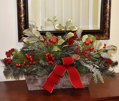 a wooden box filled with holly and red berries