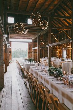 the tables are set with white linens and place settings for guests to sit at