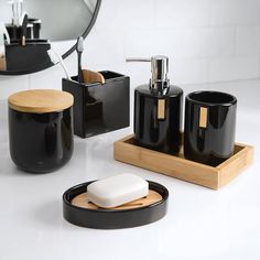 Add an updated contemporary touch to your bathroom with the Haven Toothbrush Holder by Allure Home Creation. The oblong shape of this minimalist design is featured in a rich shiny black finish accented with a light bamboo divider on top. This holder is made of ceramic with two varied sized openings. Conveniently store and organize your toothbrushes, toothpaste, or other bathroom essentials that you want to keep nearby. This classic accessory will dress your bathroom with sophisticated style. Use Black And Chrome Bathroom Fixtures, Bachelor Lifestyle, Bamboo Divider, Black Bathroom Fixtures, Bathroom Tumbler, Ball Jar, Liquid Hand Soap, Cotton Balls, Ball Jars