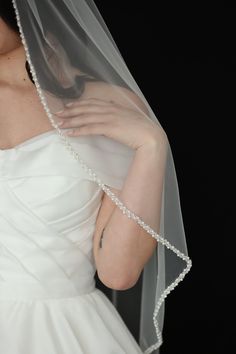 a woman in a wedding dress with a veil on her head