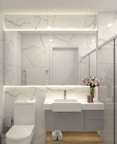 a bathroom with a toilet, sink and mirror in it's centerpieces