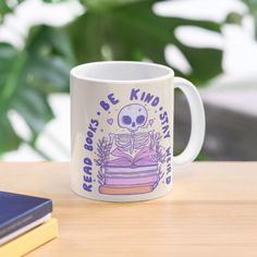 a coffee mug with a skeleton reading a book