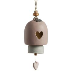 a pink birdhouse with a heart hanging from it's front end on a string