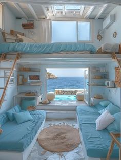 two bunk beds are in the middle of a room with an open window and view of the ocean