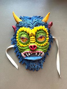 a mask with yellow and green decorations on it