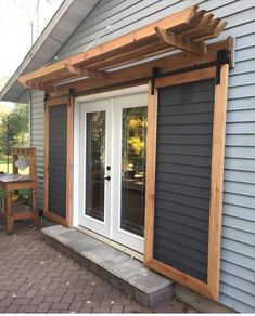 an outside patio with a wooden pergolan over the door