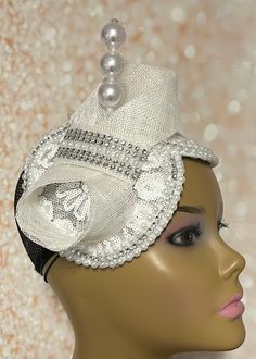 Simple, yet elegant. White Sinamay flower lace Fascinator half hat trimmed with pearls, rhinestones, and bow. The hat is affixed to the head via a hatstring. The hat measures approximately 9.5 inches X 5 inches. PLEASE NOTE All items for Free Shipping will be shipped via USPS First Class Mail.Gifts for mom, sister, wife, or yourself. White Church Hats, Lace Fascinator, Hats Design, Special Occasion Hats, White Fascinator, Womens Tea, Bridal Fascinator, Mail Gifts, Hat Fascinator