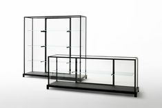 two glass cases with shelves on each side