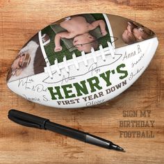 a football and pen on a wooden surface with the name henry's first year down