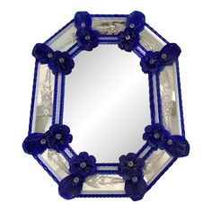 a blue and white mirror with flowers on it