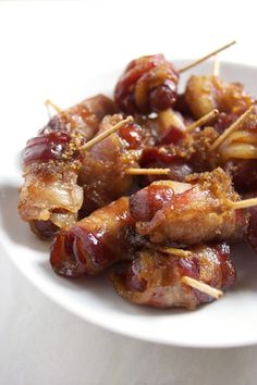 a white plate topped with meat and toothpicks