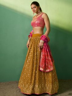 Introducing our lovely mustard sequins georgette haldi wears lehenga choli, a stunning ensemble perfect for special occasions. This beautiful lehenga choli set features a mustard yellow color georgette material lehenga adorned with exquisite sequin and embroidery work. Paired with a pink color georgette material choli featuring intricate sequin work, this set adds a touch of elegance and glamour to any event. To complete the look, a pink color organza dupatta with printed work and a beautiful se Yellow Georgette Choli For Navratri, Yellow Bandhani Print Georgette Dupatta, Yellow Georgette Dupatta With Bandhani Print, Yellow Georgette Choli, Yellow Georgette Party Wear Dupatta, Party Anarkali Set With Bandhani Print In Georgette, Yellow Bandhani Print Choli For Navratri, Yellow Georgette Lehenga With Mirror Work, Yellow Mirror Work Georgette Lehenga