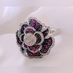 Rubies And Diamonds Adorn The Petals Of This Sterling Silver Vintage Ring Size 7 Sculpted Rose Petals In Sterling Silver, Rubies And Diamonds Early 2000’s Vintage Estate Jewelry Good Condition With Some Signs Of Wear On Bottom Of Band Luxury Silver Ruby Ring With Multi-stones, Silver Sterling Ruby Ring With Rose Cut Diamonds, Elegant Silver Ruby Flower Ring, Elegant Silver Rings With Rose Design, Elegant Red Flower Shaped Rings, Elegant Red Flower-shaped Ring, Elegant Red Flower Ring, Silver Multi-stone Flower Jewelry, Silver Ruby Ring With Diamond Accents Luxury