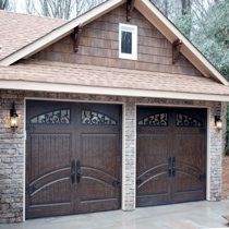 two brown garage doors in front of a house