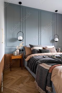 a bedroom with blue walls and wooden floors