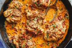 a pan filled with meat and vegetables on top of a table