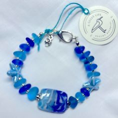 Shades Of Blues. Center Lampwork Bead, Paired With Beach Glass And Ceramic Starfish, Finished With Silver Czech Glass Beads And A Moon And Star Charm. Ceramic Starfish, Moon And Star, Glass Bracelet, Beach Glass, Star Charms, Lampwork Beads, Czech Glass Beads, Czech Glass, Starfish