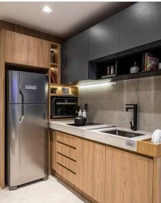 a modern kitchen with stainless steel appliances and wood cabinets