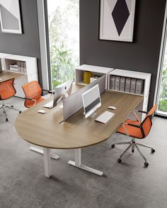 an office with two desks and orange chairs