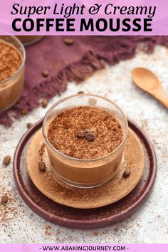 two cups filled with coffee and cinnamon on top of a plate next to spoons