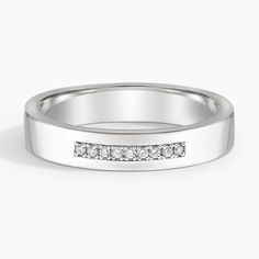 a white gold wedding ring with channeled diamonds on the side, set in 18k white gold