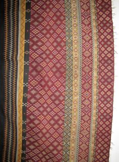 an old rug with different colors and patterns