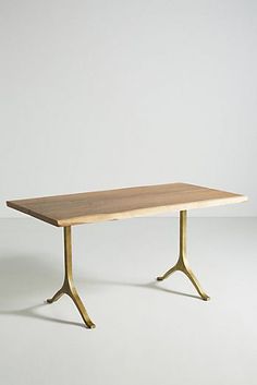 a wooden table sitting on top of a white floor