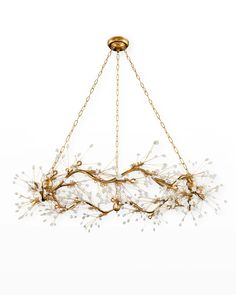 a chandelier with white flowers hanging from it's center chain, on a white background