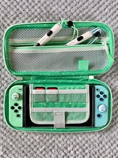 a green case with two nintendo wii game controllers in it