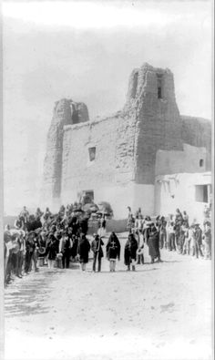 an old black and white photo of people standing in front of a building