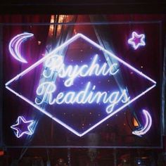 a neon sign that says psychic readings on it