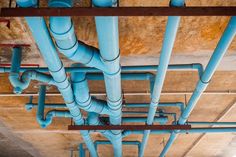 blue pipes are attached to the ceiling in an unfinished building