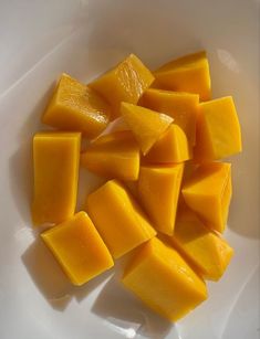 pieces of mango sitting in a white bowl