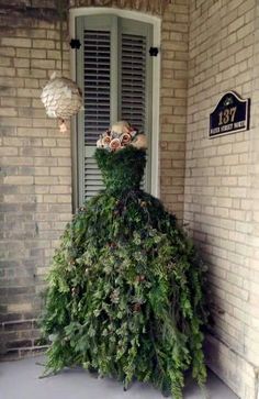 a very tall christmas tree sitting in the corner of a building next to a door