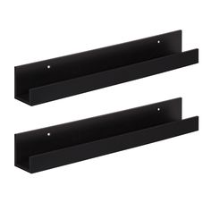 two black shelf brackets on the wall