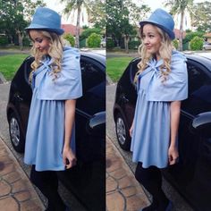 a woman standing next to a black car wearing a blue dress and hat with bow