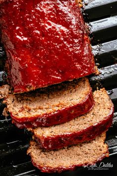 slices of meatloaf on a grill with ketchup