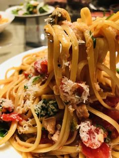 a close up of a plate of food with noodles and vegetables on it, ready to be eaten