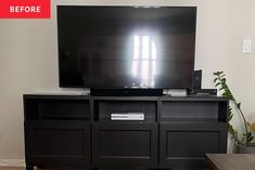 a flat screen tv sitting on top of a black entertainment center