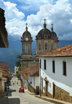 an old street with buildings and a clock tower in the background