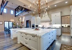 a large kitchen with an island and chandelier