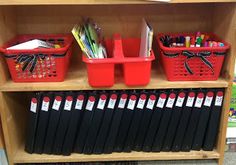 a book shelf filled with lots of books and office supplies on top of each other