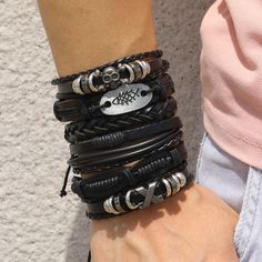 a woman's arm with several bracelets on it