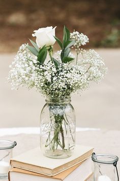 a vase filled with white flowers sitting on top of a table