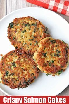 three crab cakes on a white plate next to a red and white checkered napkin