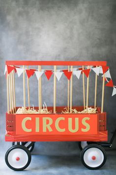 an old fashioned circus wagon with sticks in it