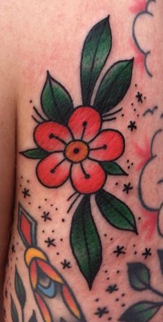 the back of a woman's stomach with flowers and leaves on her left side